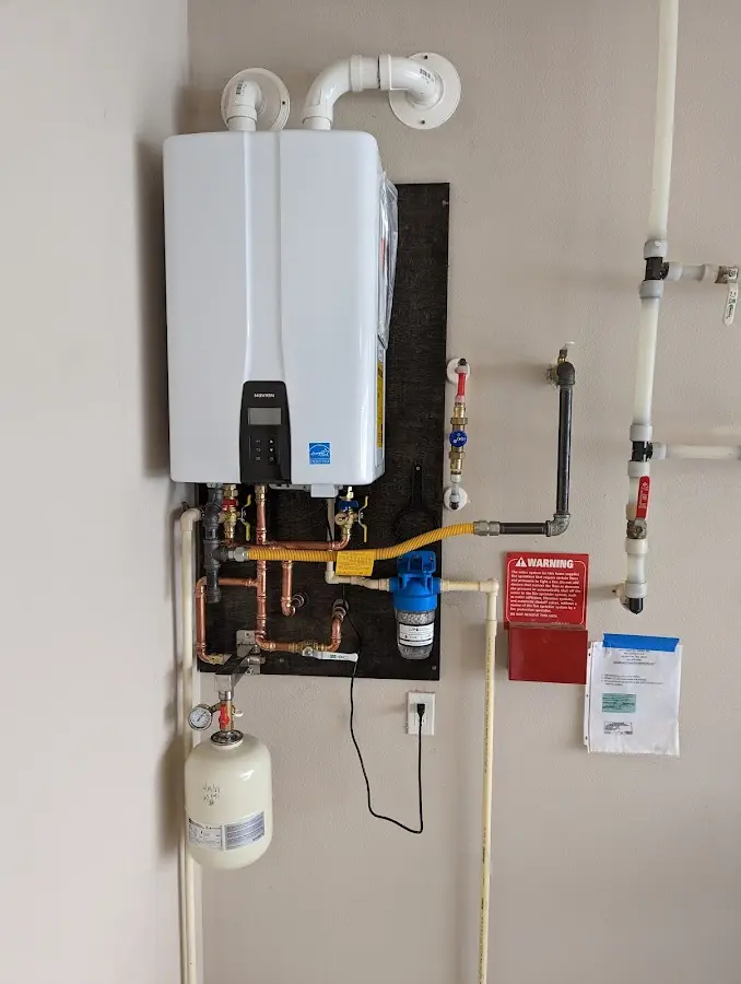 Professional plumber installing copper piping in a St. Marys home